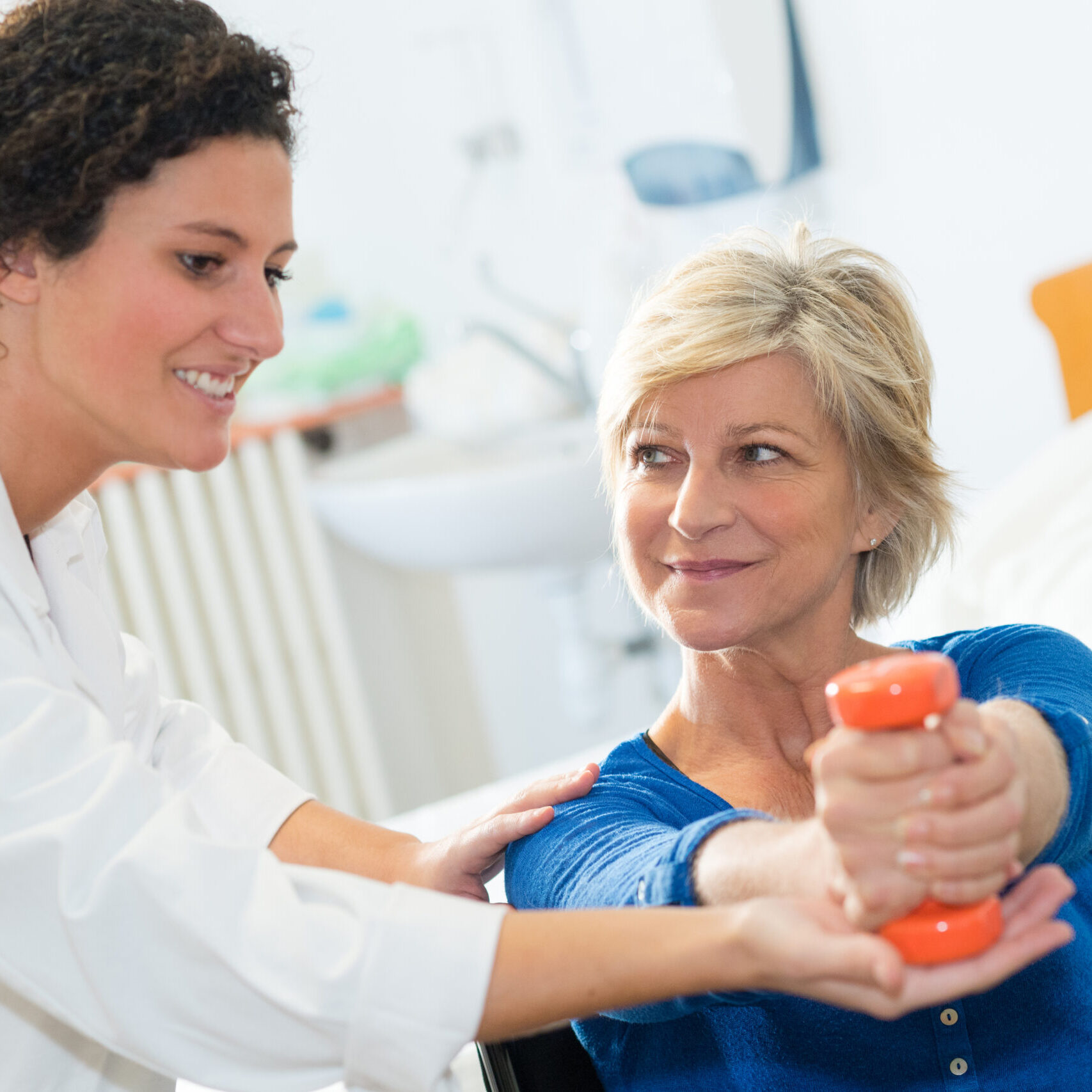 OT therapist working with patient at home