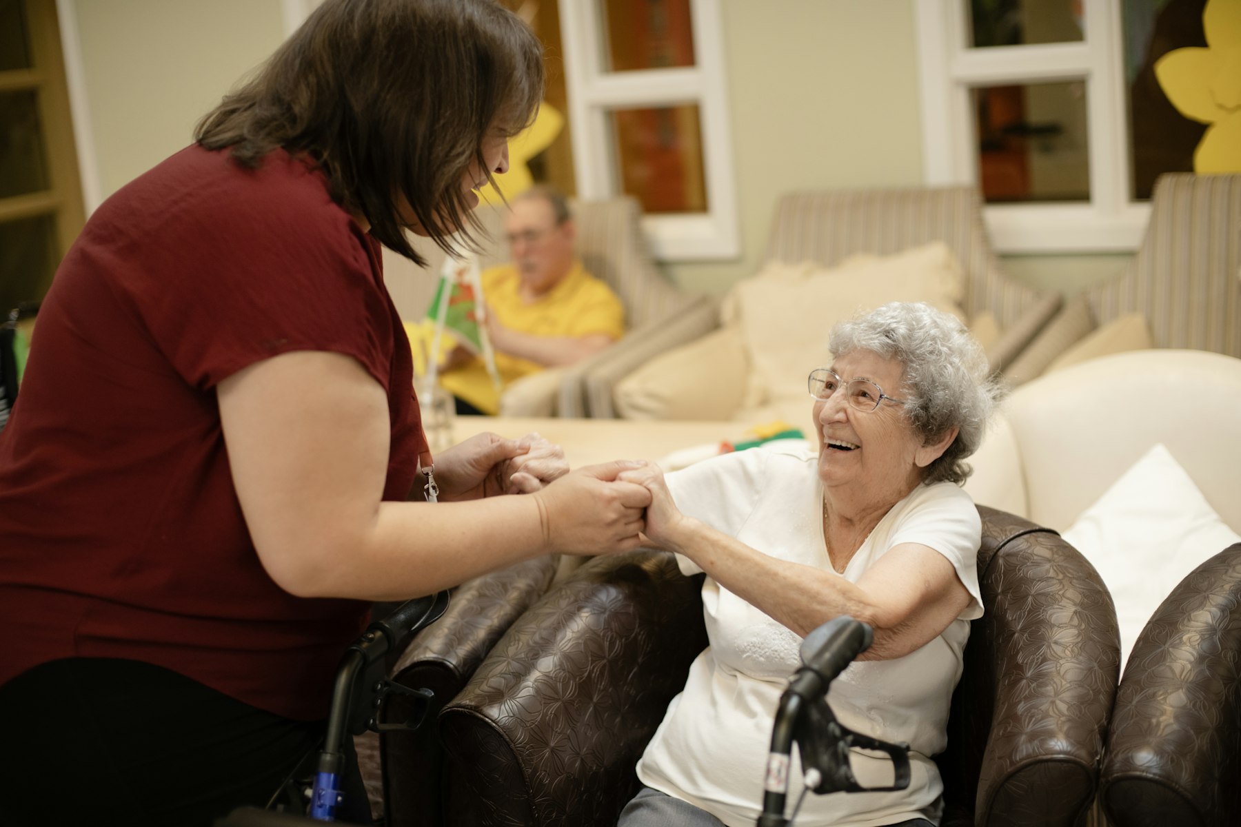 Caregiver assisting a senior patient with mobility support at home